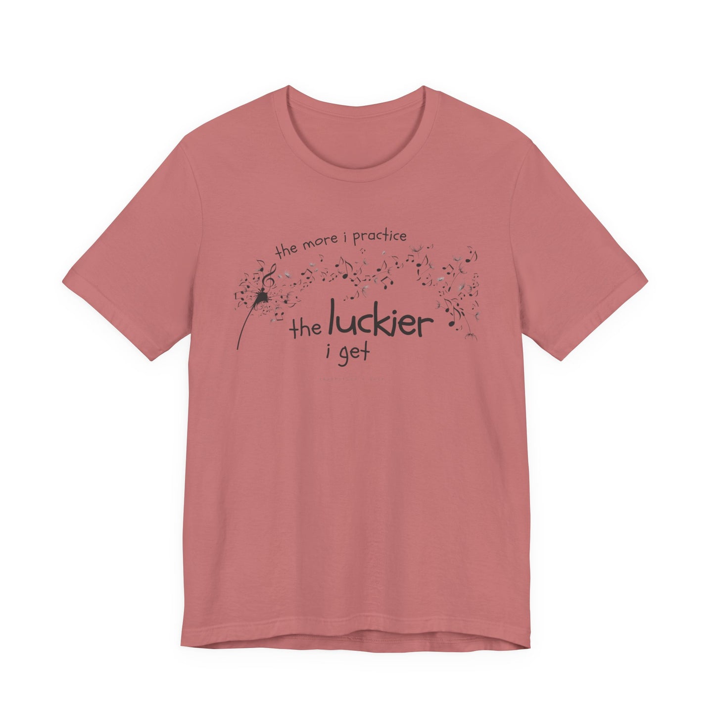 Front view of a mauve Bella Canvas t-shirt with a clever music-themed graphic. The design shows a stylized guitar headstock and musical notes above text that reads: ‘The more I practice, the luckier I get.’ Soft 100% cotton shirt perfect for musicians and music teachers.
