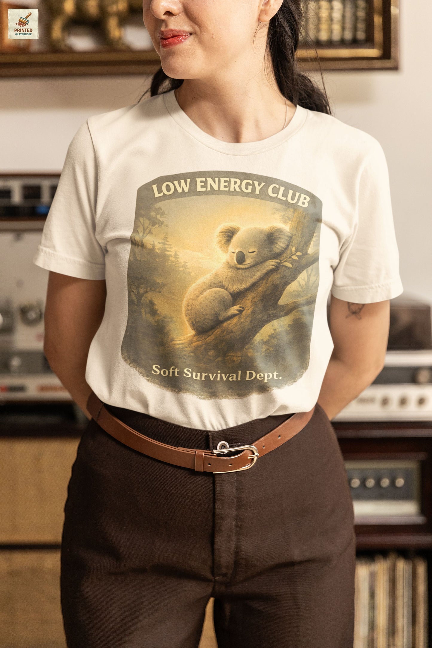 low energy club koala soft natural shirt calm aesthetic vintage design, worn by a woman standing in an antique shop