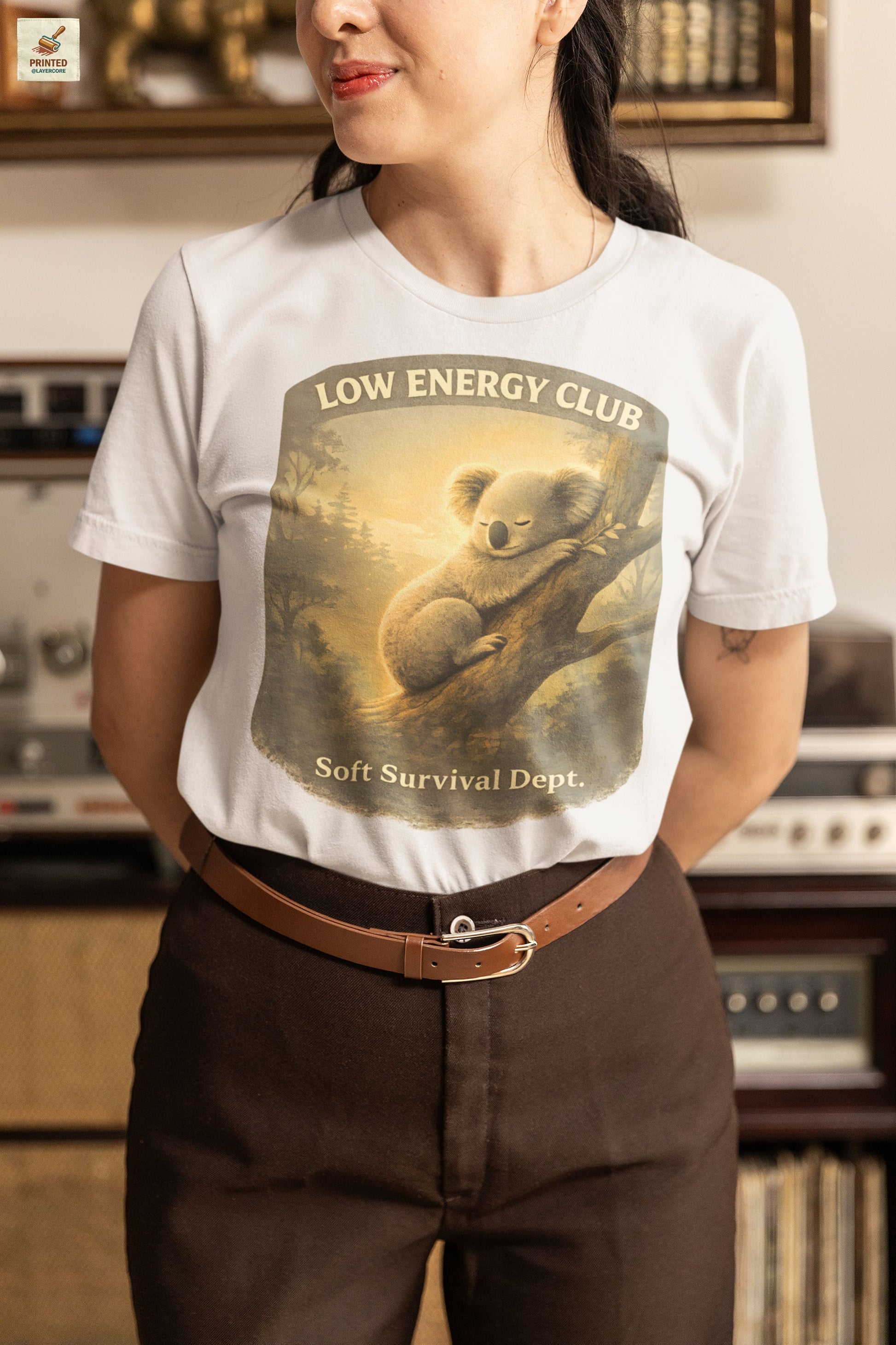 low energy club koala ash coloured shirt calm aesthetic vintage design, worn by a woman standing in an antique shop