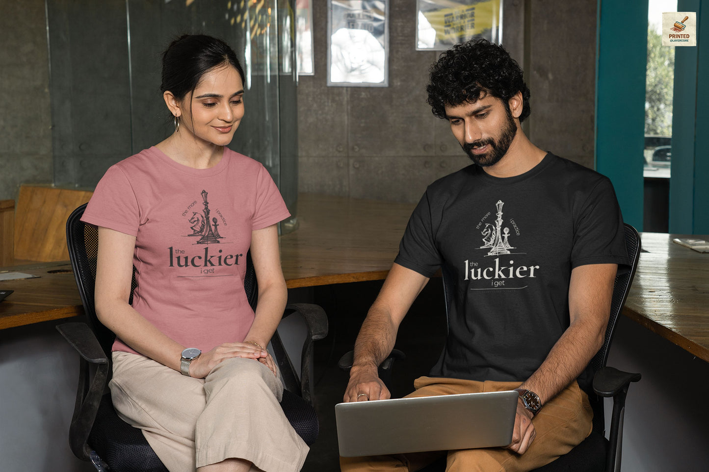 Black and mauve coloured shirt mockups showing vintage chess sketch and the phrase the more I practice the luckier I get