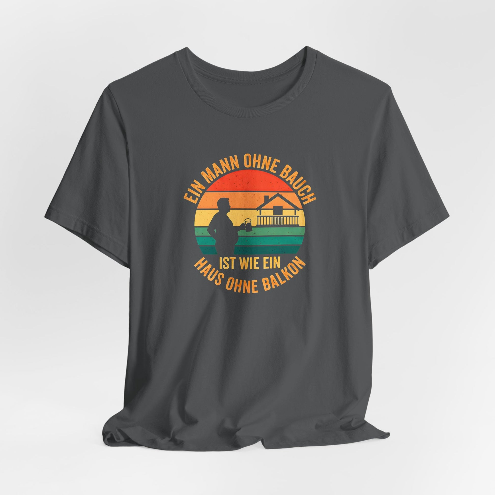 Nahaufnahme des hochwertigen Textildrucks auf dem schwarzen T-Shirt. Das runde Retro-Design zeigt die Silhouette eines Mannes mit Bierkrug neben einem Haus mit prominentem Balkon vor einem gestreiften Sonnenuntergang. Der Text "EIN MANN OHNE BAUCH IST WIE EIN HAUS OHNE BALKON" umrahmt das Motiv in einer Vintage-Schriftart. Der Druck ist scharf, die Farben sind deckend, aber nicht gummiartig, was auf eine hohe Qualität hindeutet. Man erkennt die weiche Textur der Baumwolle des Bella Canvas 3001 Shirts.