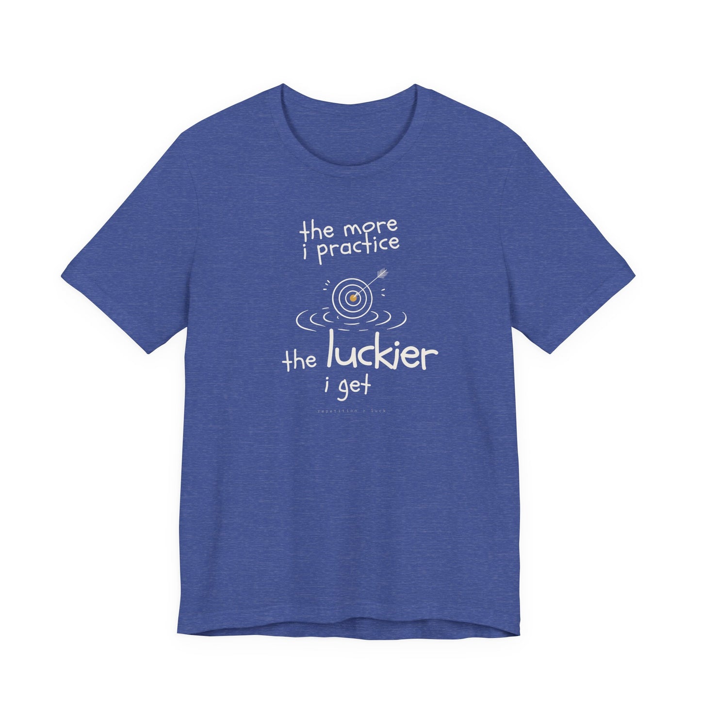 Minimalist motivational T-shirt design shown on a blue shirt: hand-drawn cream lettering reads “the more i practice” above a sketched bullseye with an arrow and small mustard center, ripple lines underneath, then larger text reads “the luckier i get” with tiny mono text below that says “repetition > luck.”